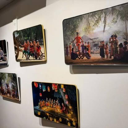 Framed photographs of Myanmar festival scenes and lantern nights on the restaurant wall