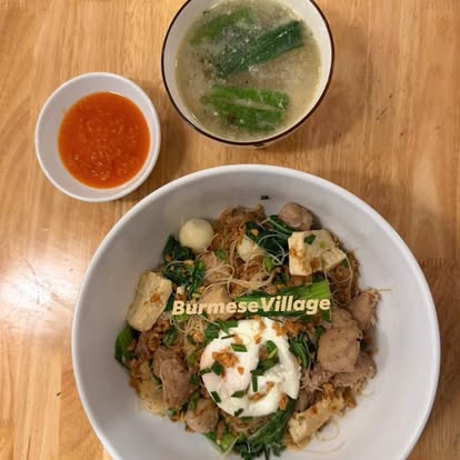 Vermicelli bowl with tofu, greens and a poached egg, served with soup and chili sauce